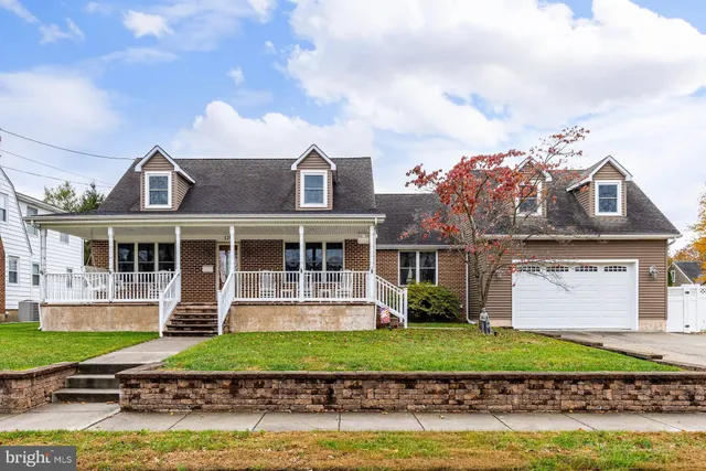a front view of a house with a garden and plants