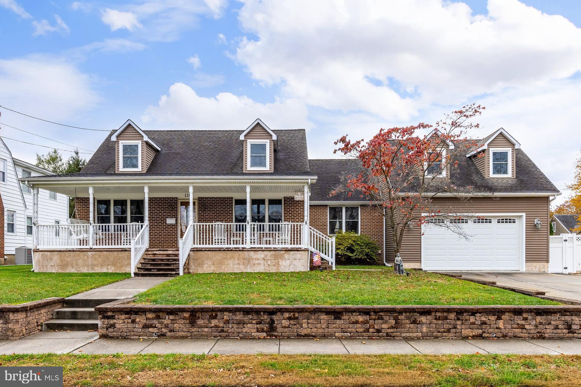 a front view of a house with a garden and plants