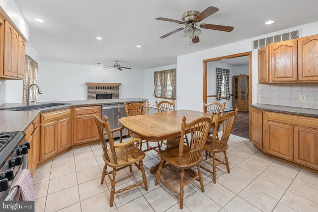 a kitchen with kitchen island granite countertop a sink and a refrigerator