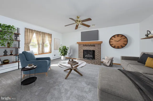 an empty room with chandelier fan and windows