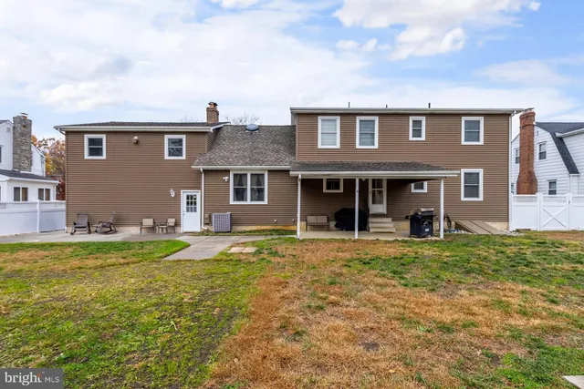a view of a house with a yard and sitting area