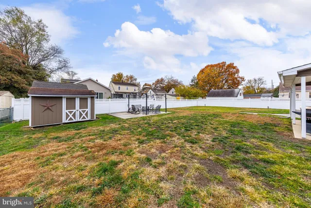 a front view of a house with a garden and yard