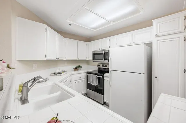 a white refrigerator freezer sitting inside of a kitchen