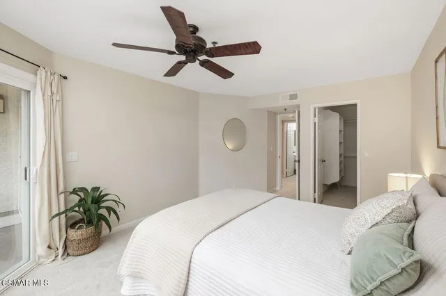 a bedroom with a bed and ceiling fan