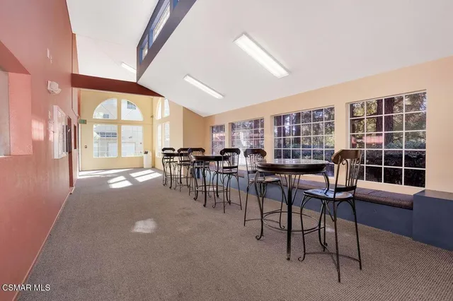 a dining room with furniture and a large window