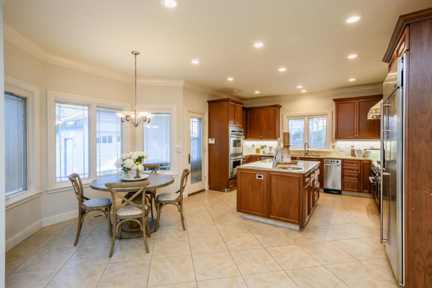 840 Newhall Road Burlingame, CA 94010 - Photo 11 of 41 a view of a dining room and livingroom with furniture wooden floor and a chandelier