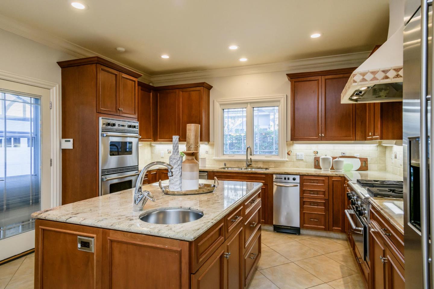 840 Newhall Road Burlingame, CA 94010 - Photo 15 of 41 a kitchen with stainless steel appliances a sink stove and cabinets