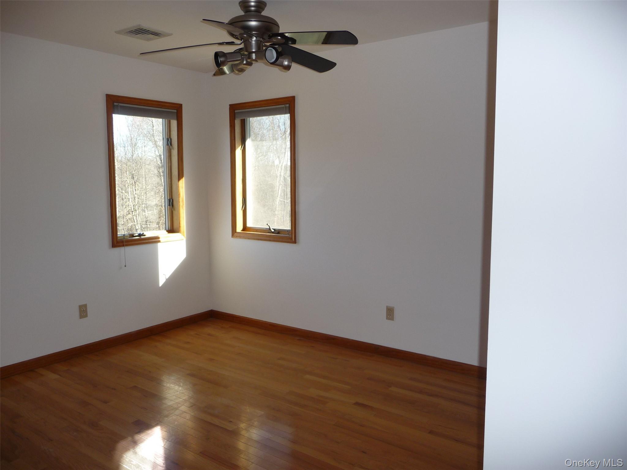 49 Lane Gate Road Wappingers Falls, NY 12590 - Photo 16 of 47 a view of an empty room with wooden floor and a window