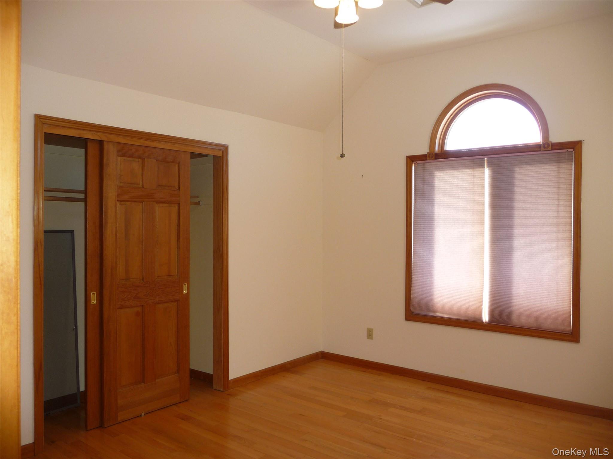 49 Lane Gate Road Wappingers Falls, NY 12590 - Photo 19 of 47 an empty room with wooden floor closet and windows