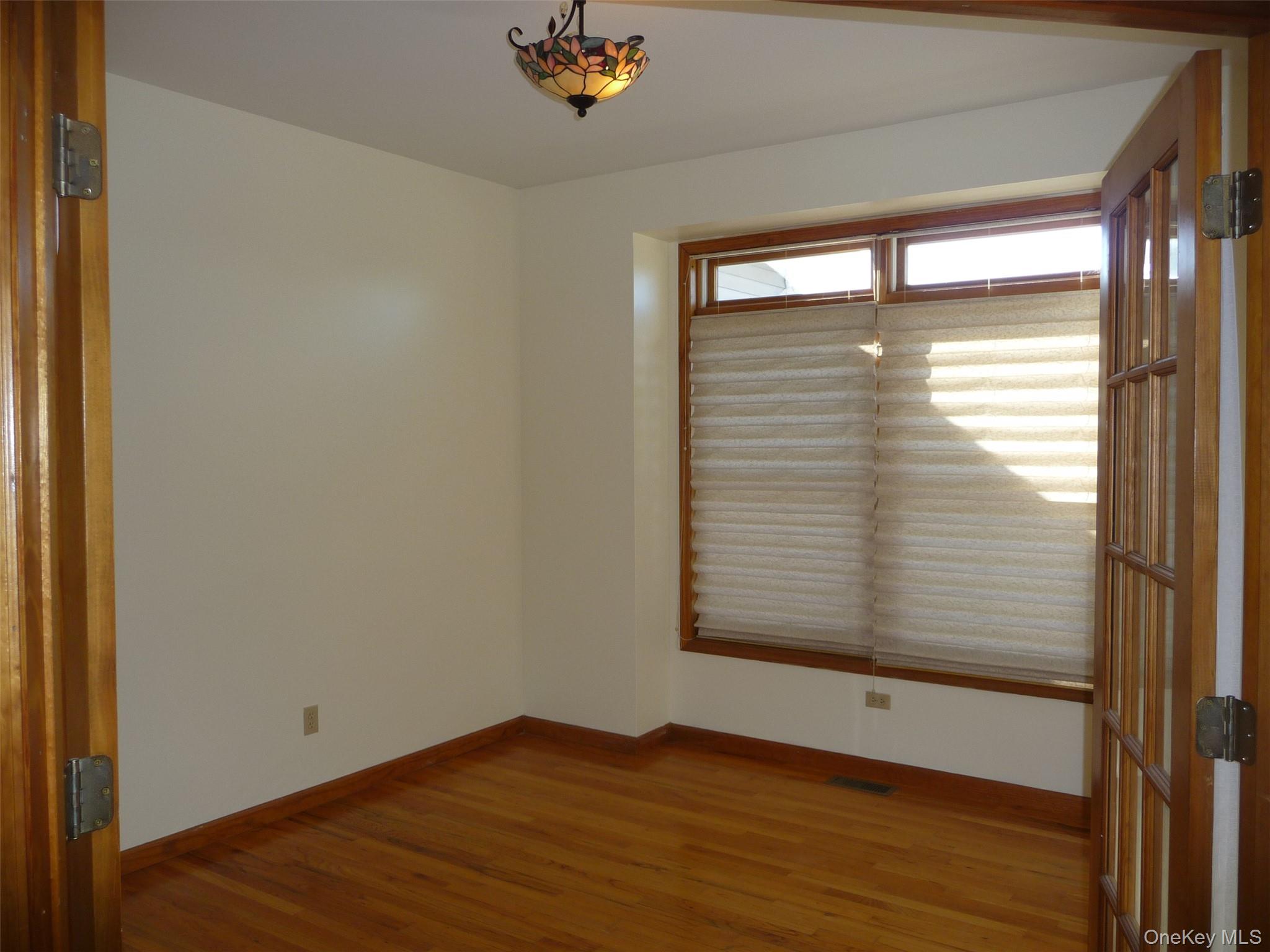 49 Lane Gate Road Wappingers Falls, NY 12590 - Photo 4 of 47 a view of an empty room with wooden floor and a window
