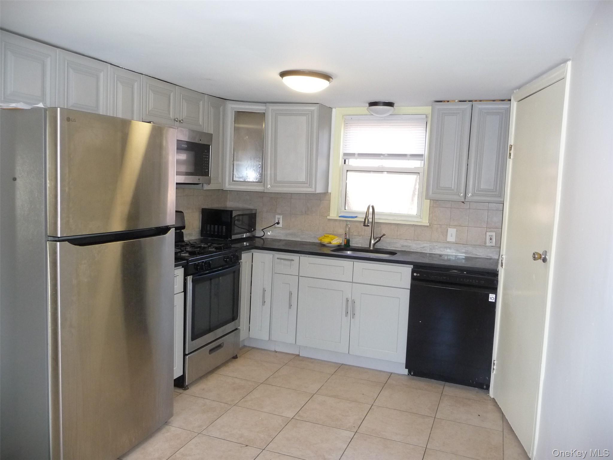 49 Lane Gate Road Wappingers Falls, NY 12590 - Photo 46 of 47 a kitchen with a refrigerator sink and microwave