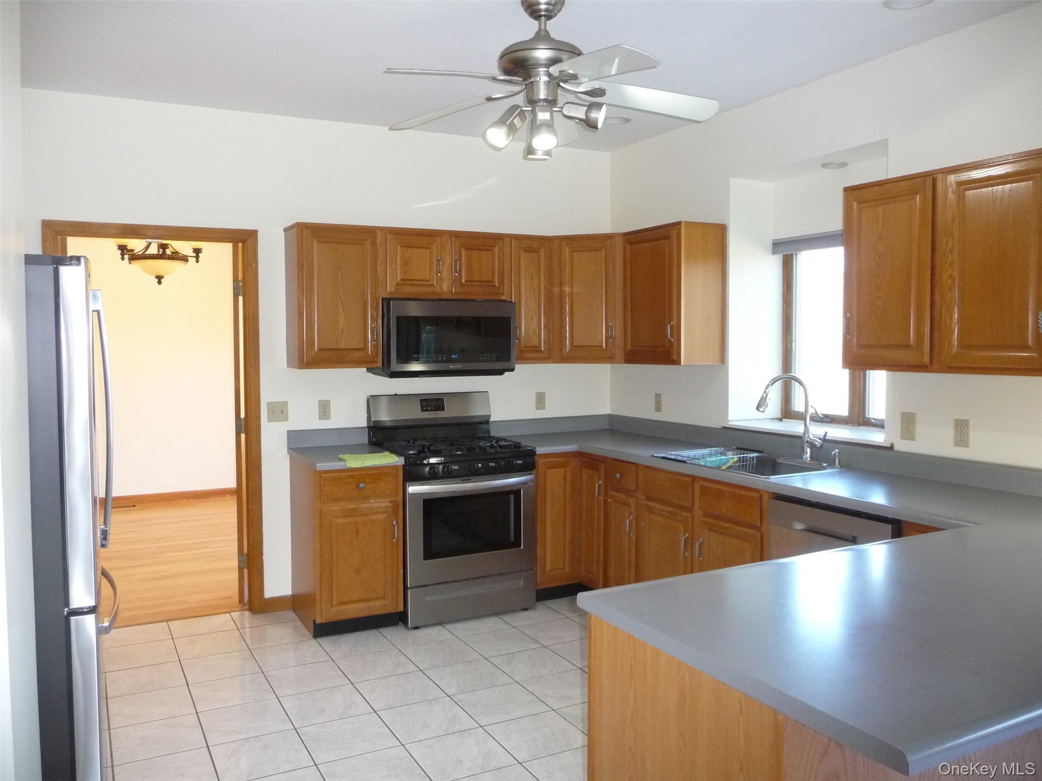 49 Lane Gate Road Wappingers Falls, NY 12590 - Photo 6 of 47 a kitchen with stainless steel appliances granite countertop a sink and a stove