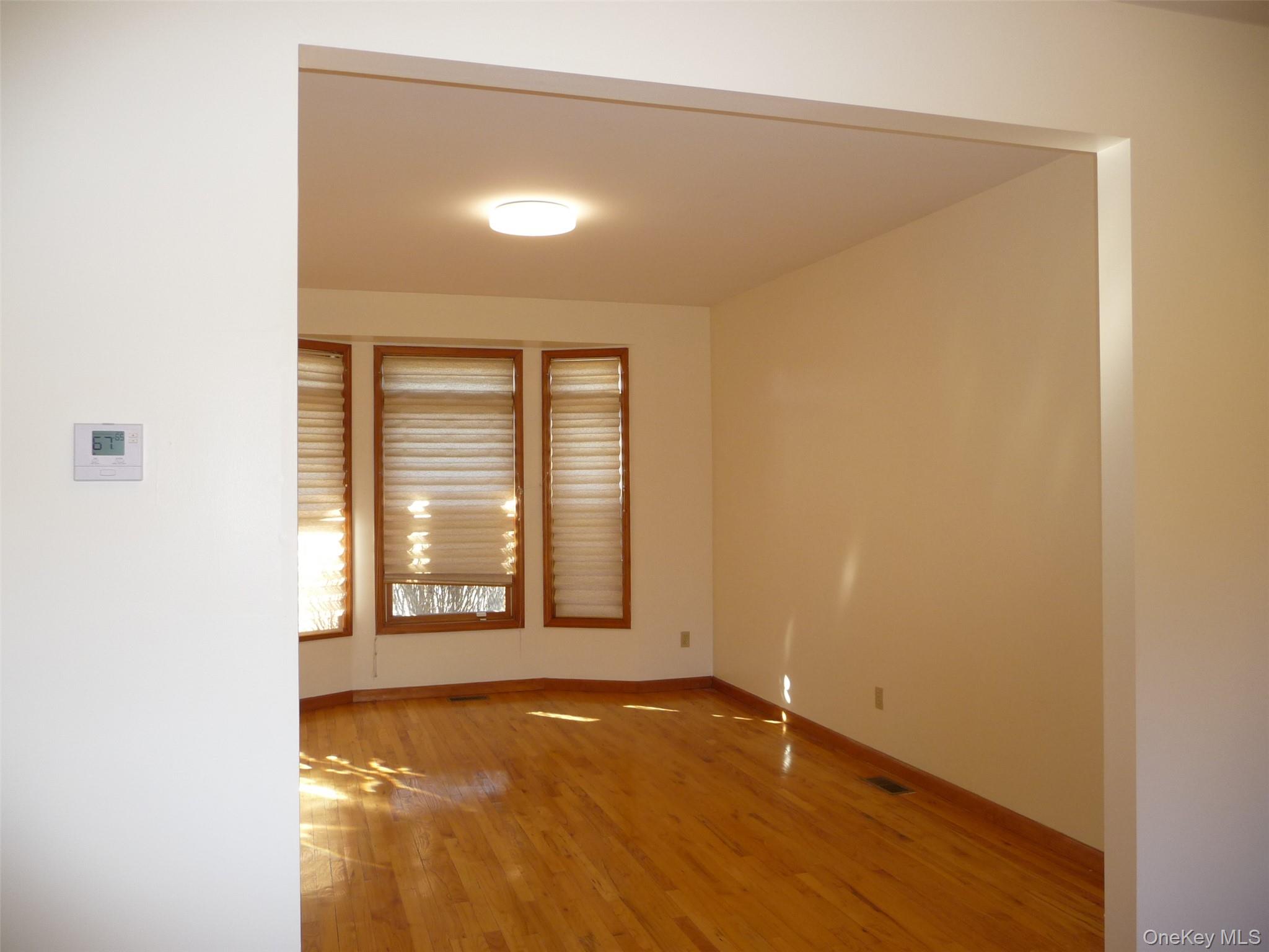 49 Lane Gate Road Wappingers Falls, NY 12590 - Photo 7 of 47 an empty room with wooden floor and windows