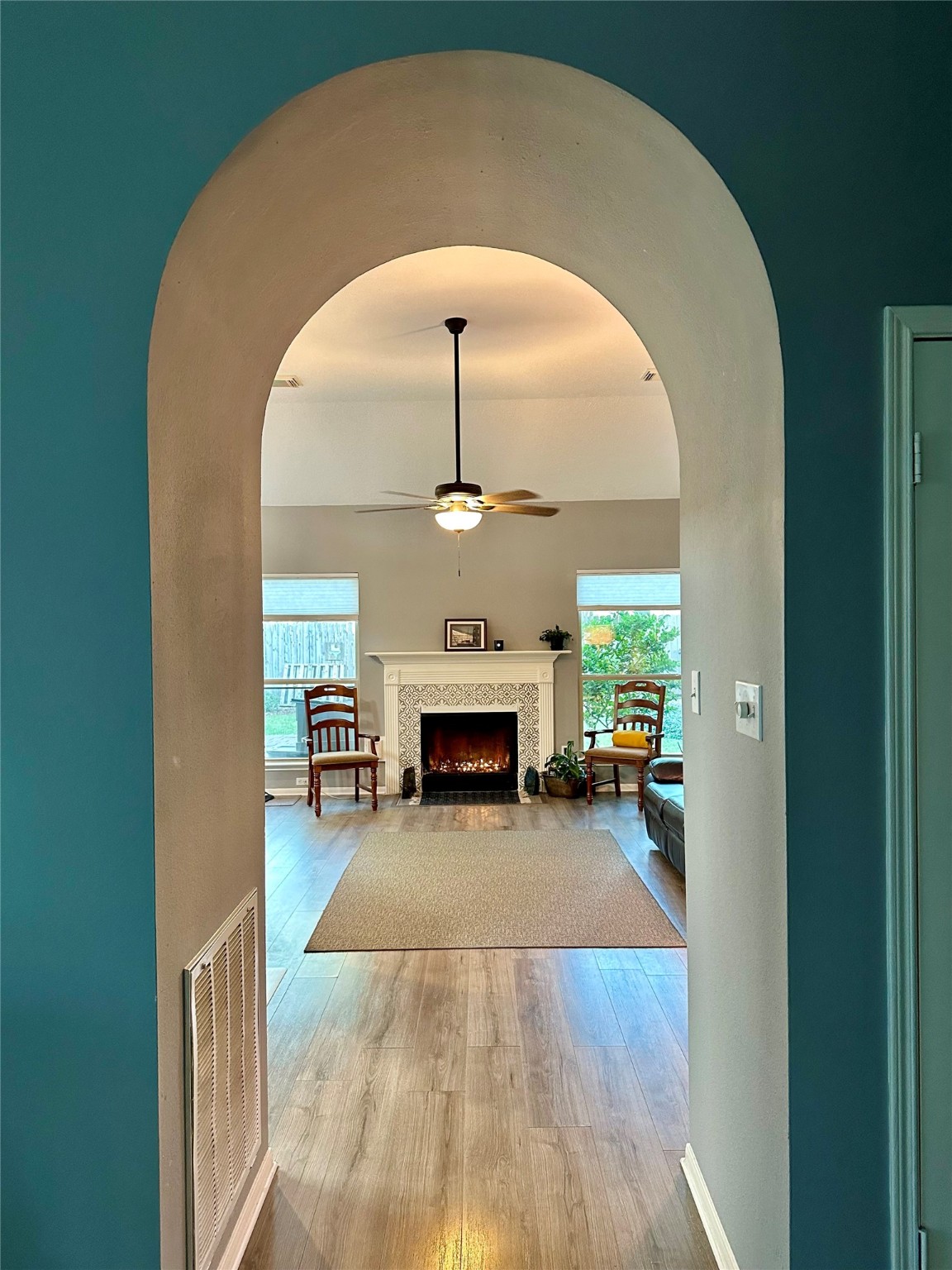 12922 Mills Bend Street Houston, TX 77070 - Photo 12 of 50 a view of a livingroom with a fireplace a chandelier and wooden floor