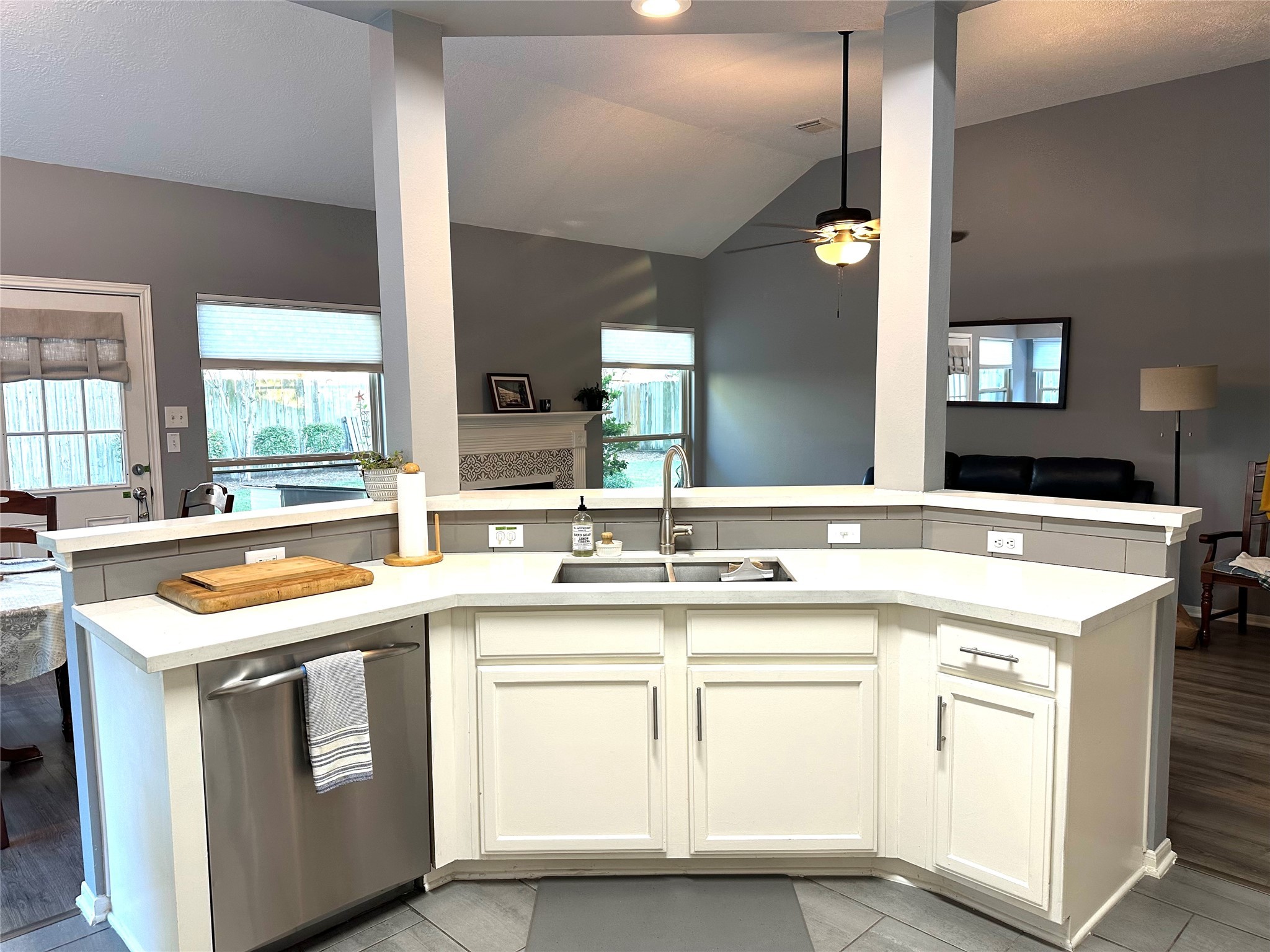 12922 Mills Bend Street Houston, TX 77070 - Photo 20 of 50 a kitchen with stainless steel appliances granite countertop a sink and white cabinets with wooden floor