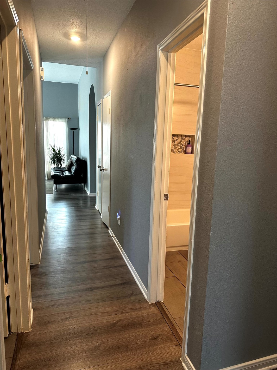 12922 Mills Bend Street Houston, TX 77070 - Photo 38 of 50 a view of a hallway with wooden floor and a living room