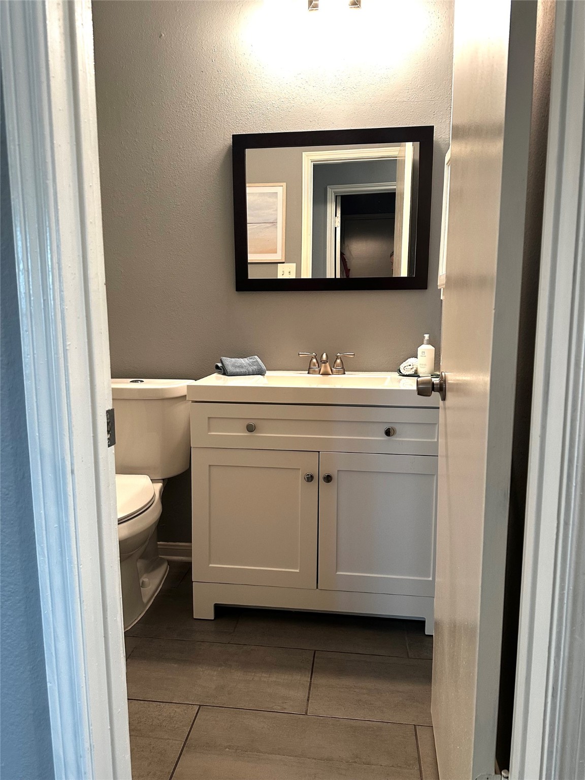 12922 Mills Bend Street Houston, TX 77070 - Photo 39 of 50 a bathroom with a toilet sink and mirror