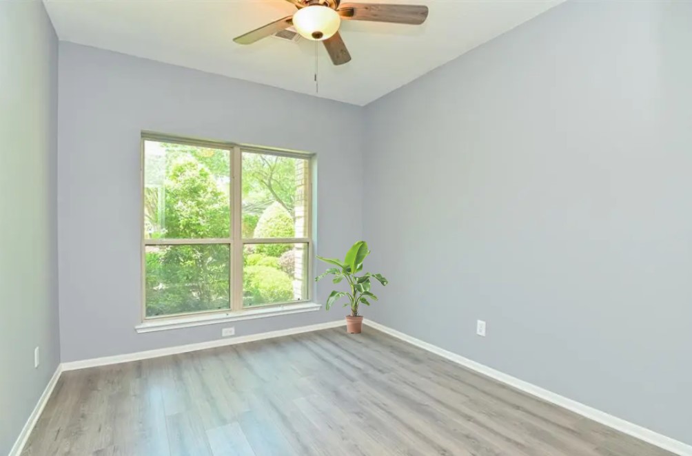 12922 Mills Bend Street Houston, TX 77070 - Photo 42 of 50 an empty room with wooden floor and windows