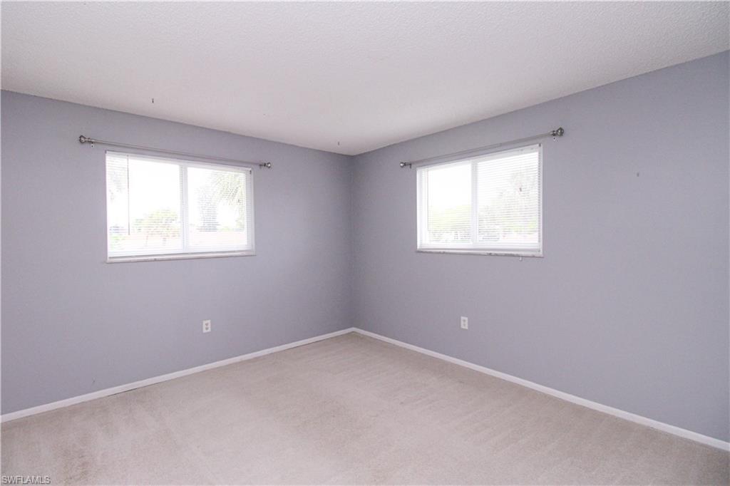 729 Palm View Drive, Unit D4 Naples, FL 34110 - Photo 14 of 23 an empty room with windows