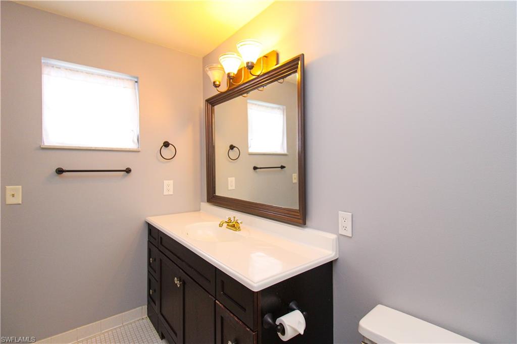 729 Palm View Drive, Unit D4 Naples, FL 34110 - Photo 19 of 23 a bathroom with a sink toilet and window