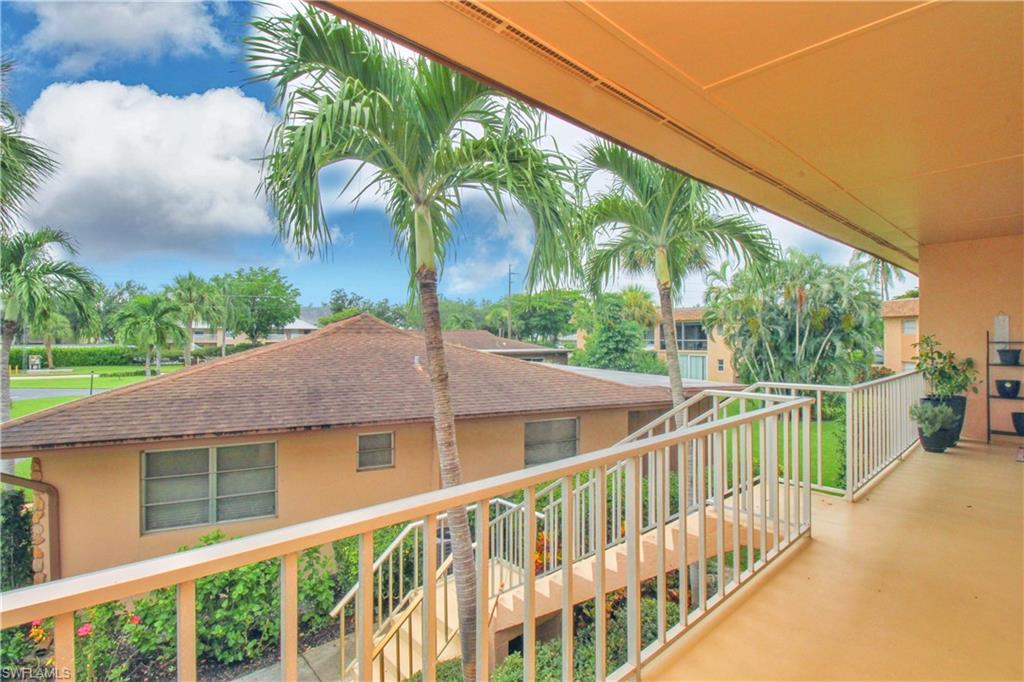 729 Palm View Drive, Unit D4 Naples, FL 34110 - Photo 4 of 23 a view of a house with a small yard and wooden fence
