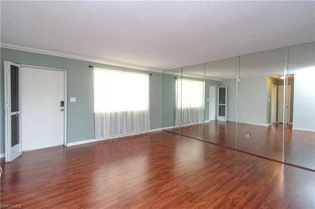 a view of wooden floor and windows in an empty room