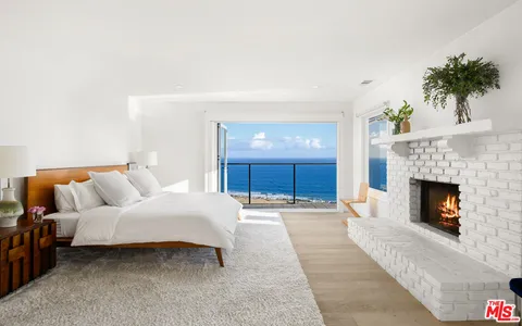 a bedroom with a large bed and a flat screen tv