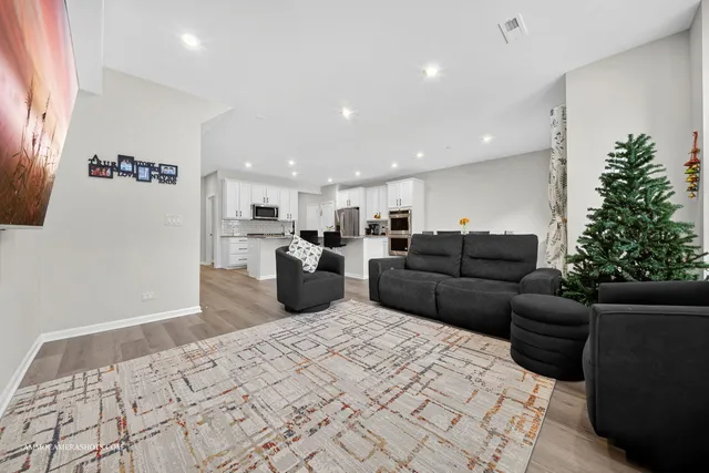 a living room with furniture window and potted plant
