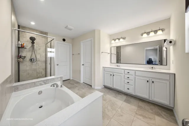 a bathroom with a bathtub and a shower