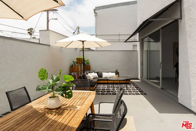 a view of a backyard with table and chairs