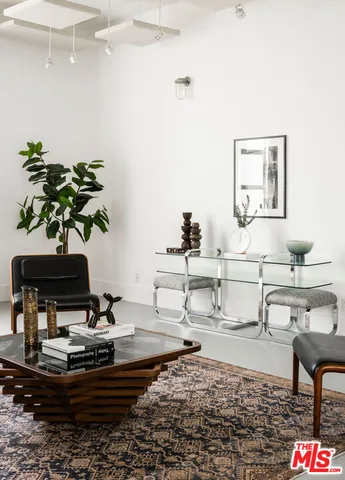 a living room with furniture and flowers