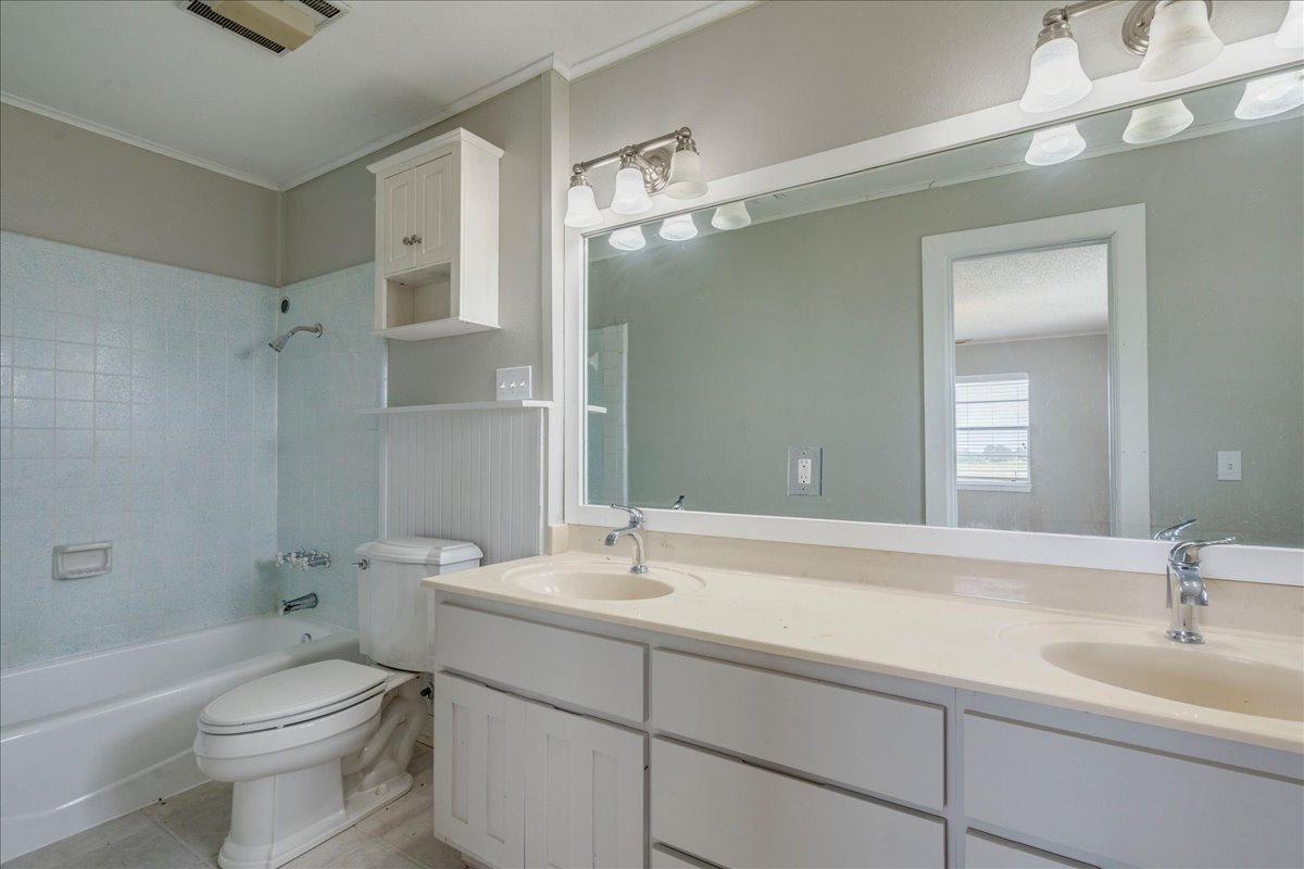 595 Cardinal Road Rosanky, TX 78953 - Photo 20 of 39 a bathroom with a sink a toilet and shower