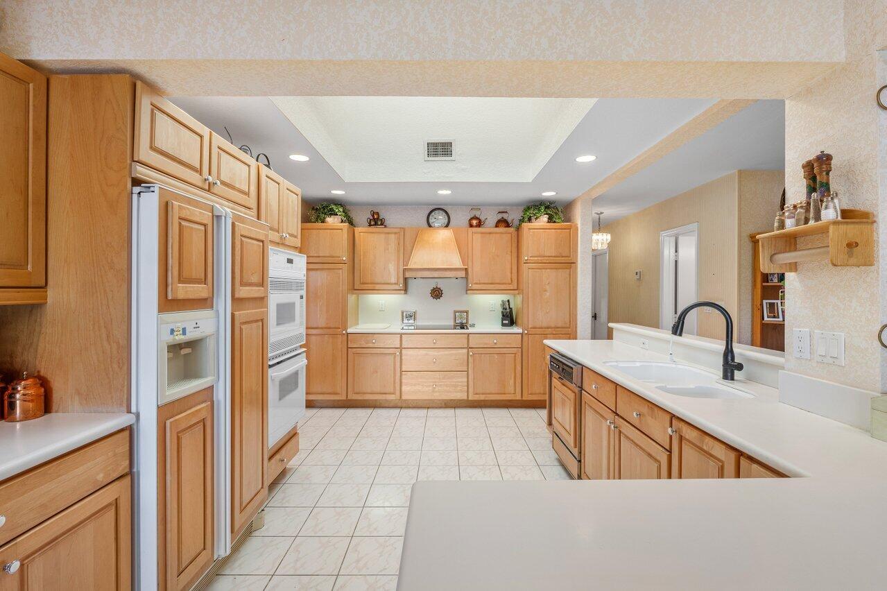 3163 Northeast 8th Avenue Boca Raton, FL 33431 - Photo 14 of 31 a large white kitchen with a large window