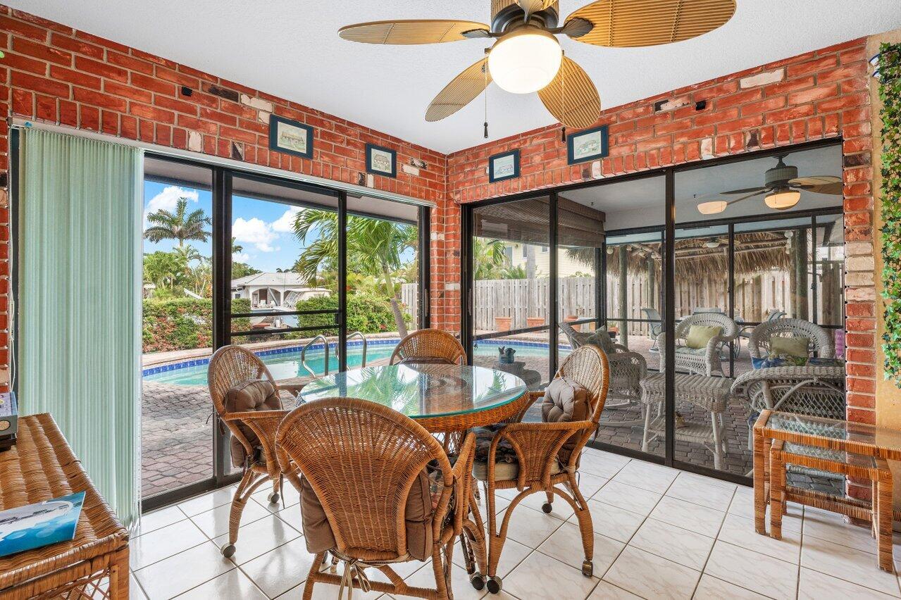 3163 Northeast 8th Avenue Boca Raton, FL 33431 - Photo 17 of 31 a dining room with furniture water view and balcony