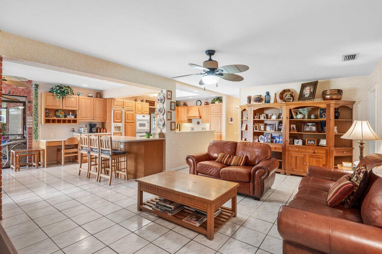 3163 Northeast 8th Avenue Boca Raton, FL 33431 - Photo 18 of 31 a living room with furniture a dining table and a piano table