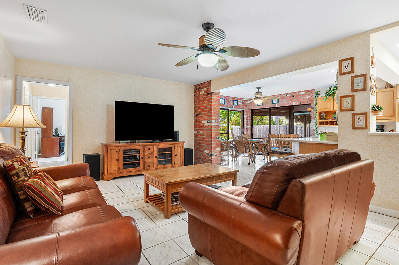 3163 Northeast 8th Avenue Boca Raton, FL 33431 - Photo 19 of 31 a living room with furniture and a flat screen tv