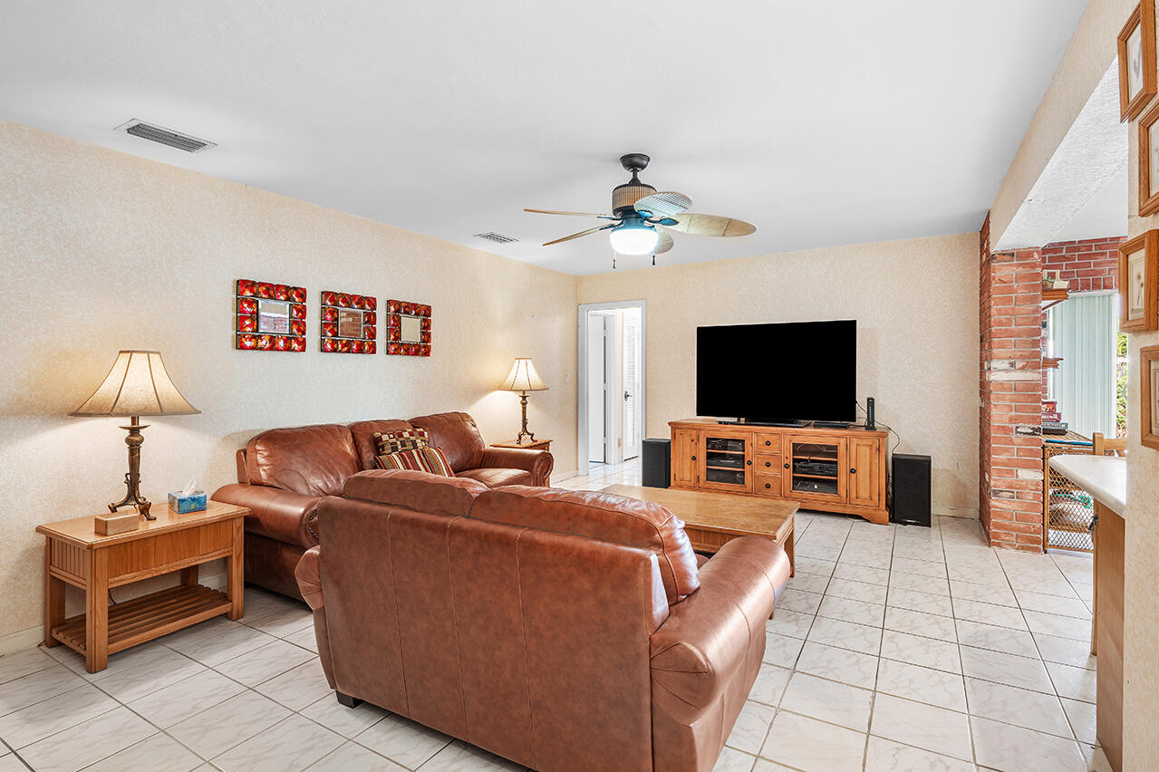 3163 Northeast 8th Avenue Boca Raton, FL 33431 - Photo 20 of 31 a living room with furniture and a flat screen tv