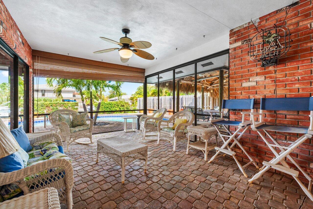 3163 Northeast 8th Avenue Boca Raton, FL 33431 - Photo 21 of 31 a living room with patio furniture and a large window