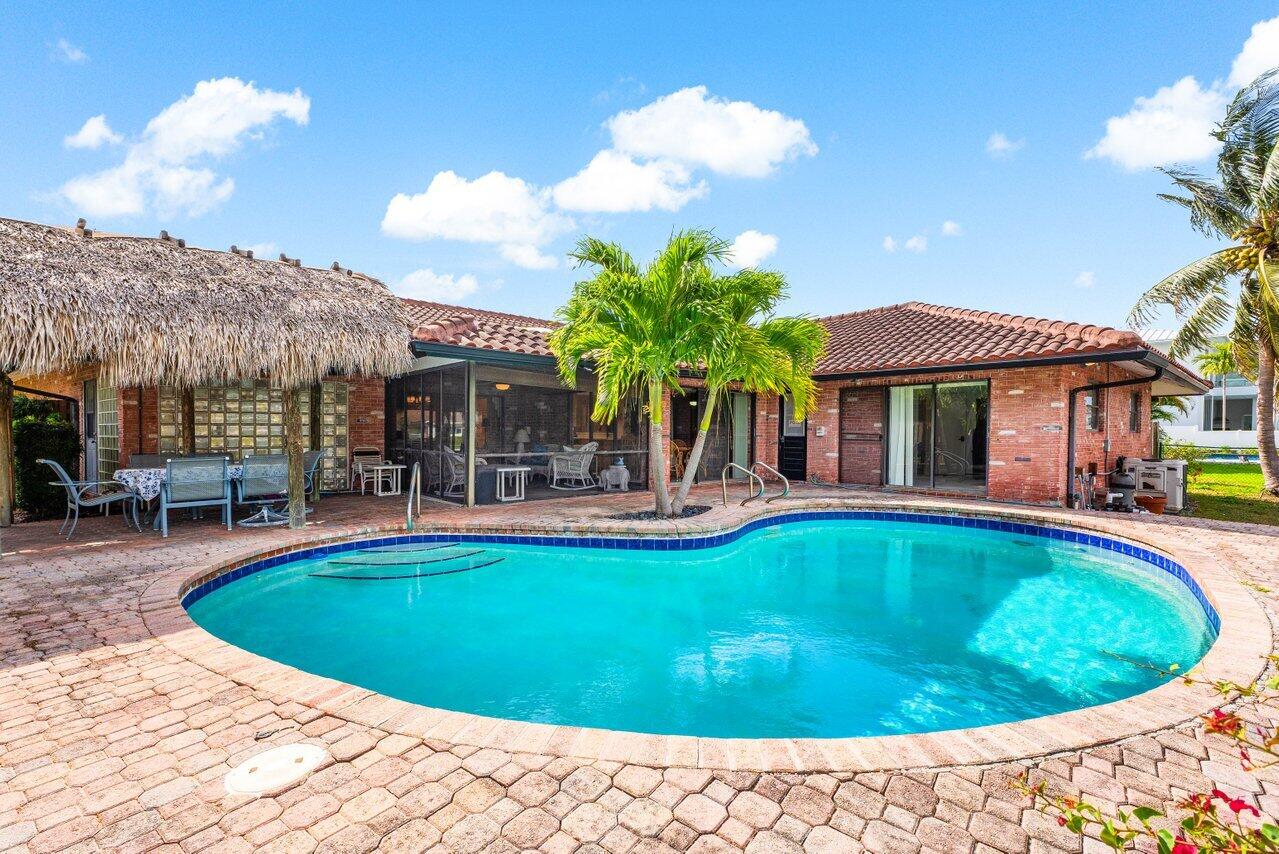 3163 Northeast 8th Avenue Boca Raton, FL 33431 - Photo 23 of 31 a view of a house with swimming pool and sitting area