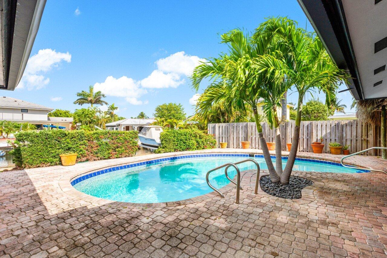 3163 Northeast 8th Avenue Boca Raton, FL 33431 - Photo 24 of 31 a view of a swimming pool with a patio