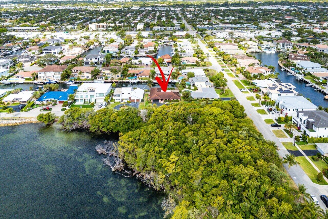 3163 Northeast 8th Avenue Boca Raton, FL 33431 - Photo 26 of 31 an aerial view of residential houses with outdoor space and trees