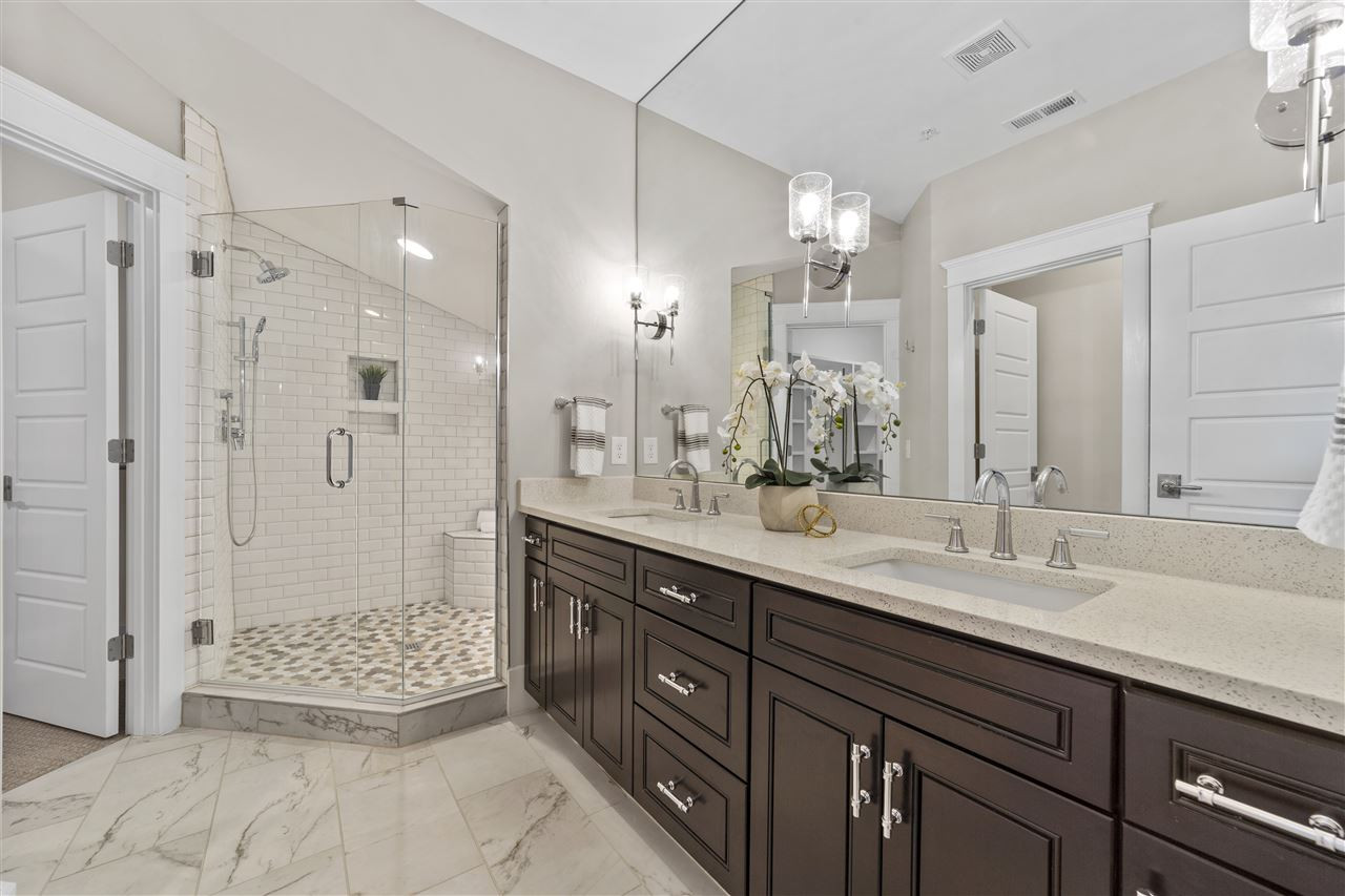 503 Hamilton Cottage Way Raleigh, NC 27605 - Photo 17 of 30 a bathroom with a sink double vanity and a shower