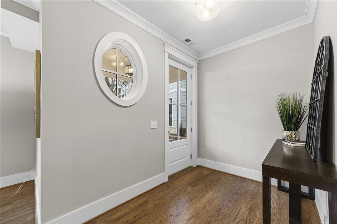 503 Hamilton Cottage Way Raleigh, NC 27605 - Photo 4 of 30 a view of a room with a table and a potted plant