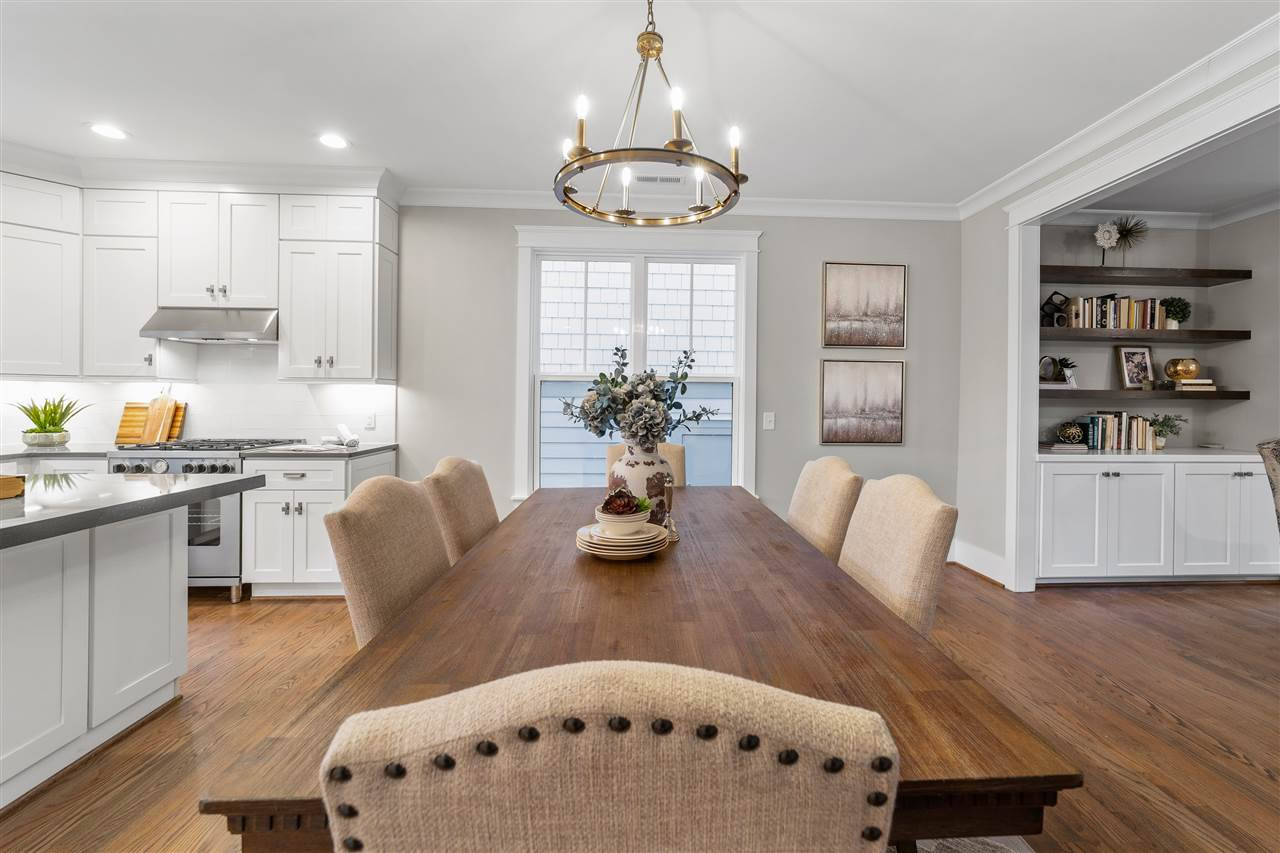 503 Hamilton Cottage Way Raleigh, NC 27605 - Photo 8 of 30 a kitchen with stainless steel appliances granite countertop a dining table chairs and a dining table with wooden floor