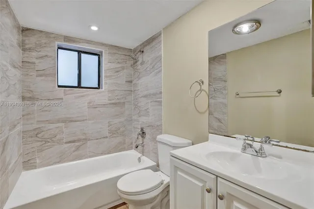 a bathroom with a sink a toilet and bathtub