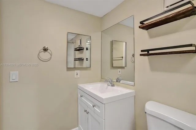 a bathroom with a sink toilet and vanity