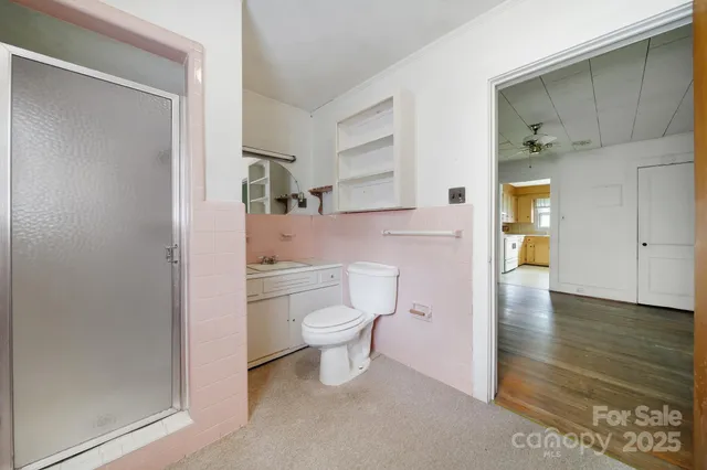a bathroom with a toilet and a shower