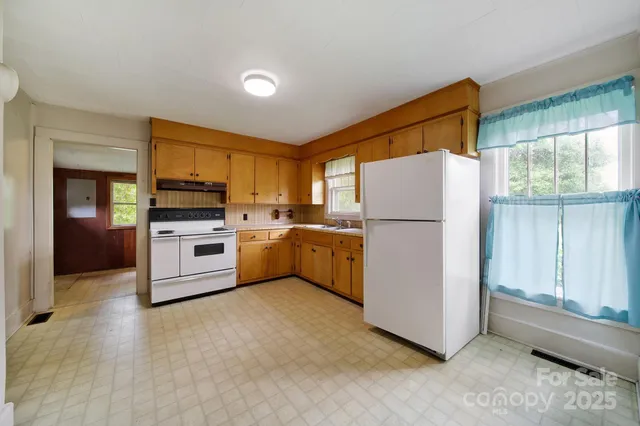 a kitchen with stainless steel appliances a refrigerator sink and cabinets