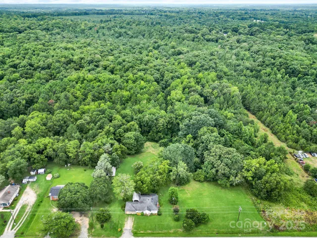 a front view of a house with a yard and green space