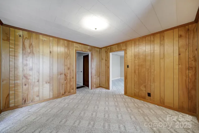 a view of empty room with wooden walls